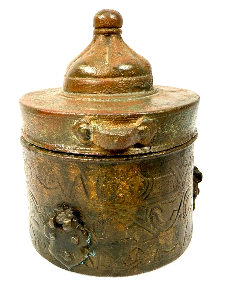 Antique Khorassan bronze inkwell featuring a broad circular lid with raised horizontal mouldings and a prominent rounded finial.