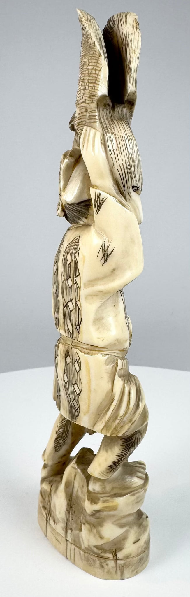 Rear view showing incised garments and sectional construction of the Japanese okimono