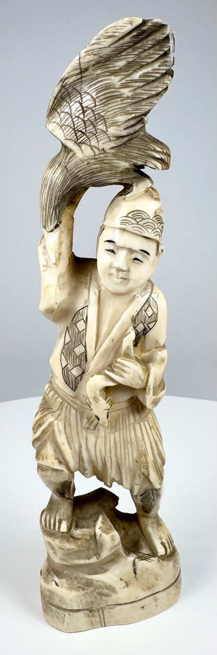 Front view of a Japanese sectional okimono depicting a falconer and raptor