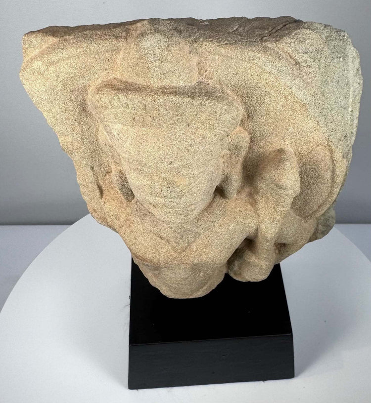 Angled perspective of carved stone bust highlighting three-dimensional facial depth and hair details