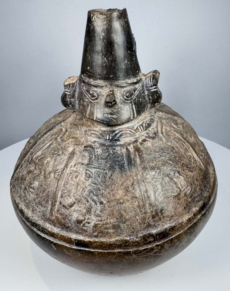 Pre-Columbian Naymlap-style bottle from northern Peru with dark burnished finish and traditional Sicán form.