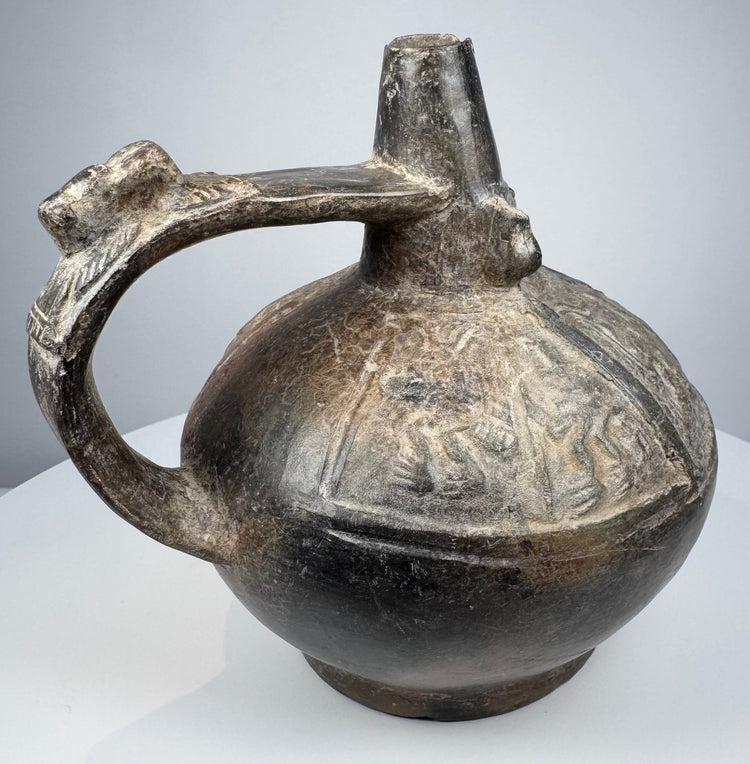 Pre-Columbian Sicán ritual vessel with compact rounded form and naturally aged burnished black surface.