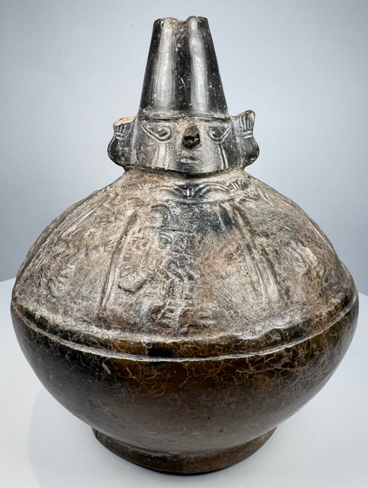 Sicán Naymlap ceramic vessel from Peru showing dark polished blackware and centuries-old surface wear.