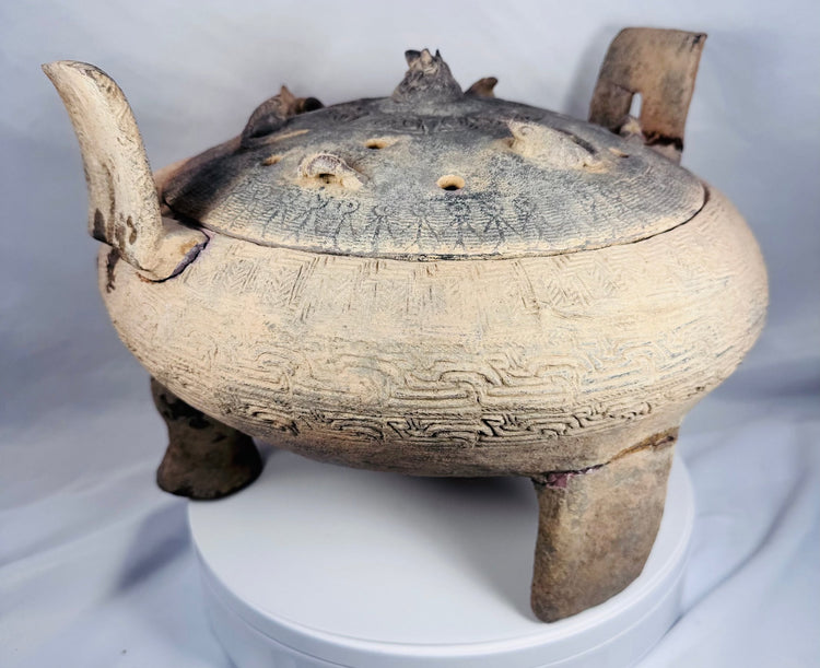 Close-up of the pierced domed lid featuring applied miniature animal figures from an ancient Chinese ritual vessel.