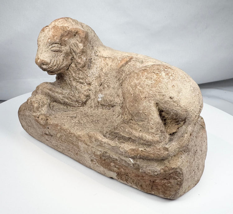 Hellenistic Egyptian terracotta reclining lion with surface encrustation and age wear