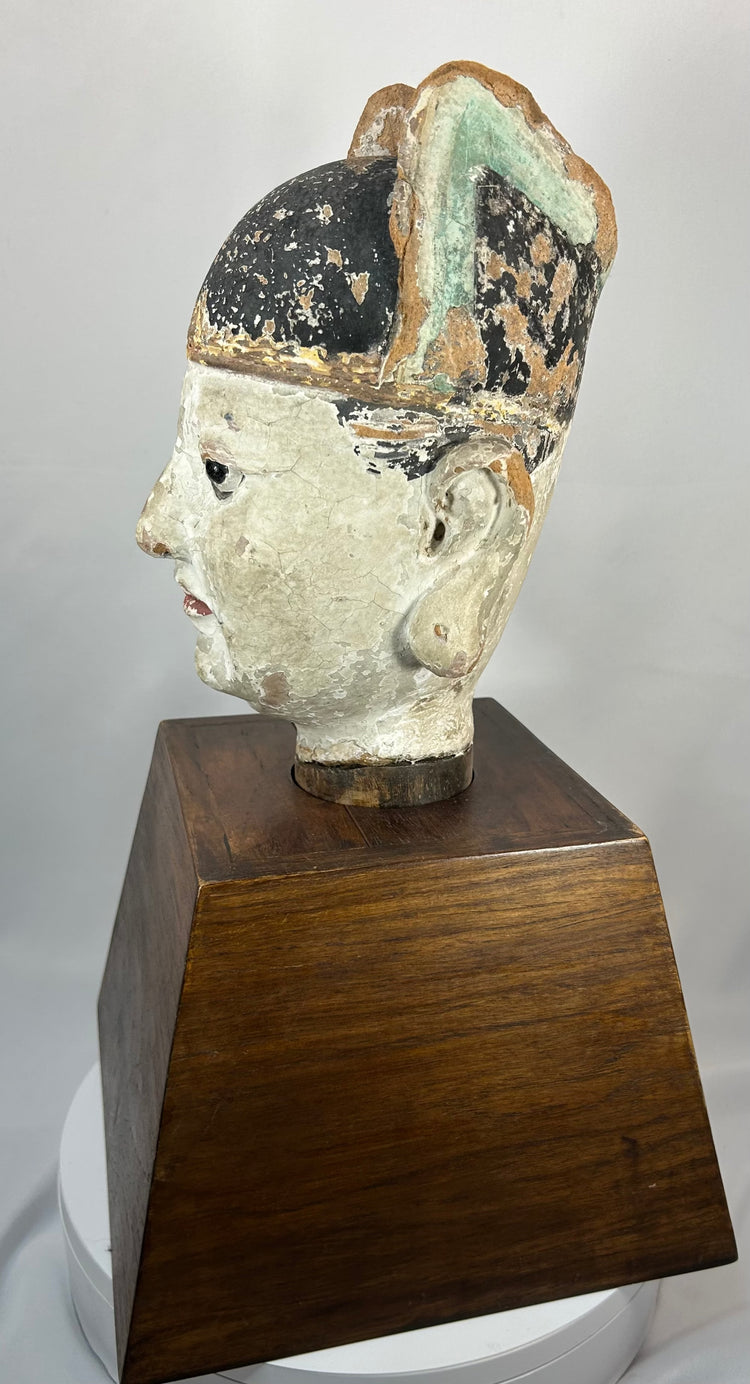 Chinese temple bust of a scholar-official with black ceremonial hat and red lips.