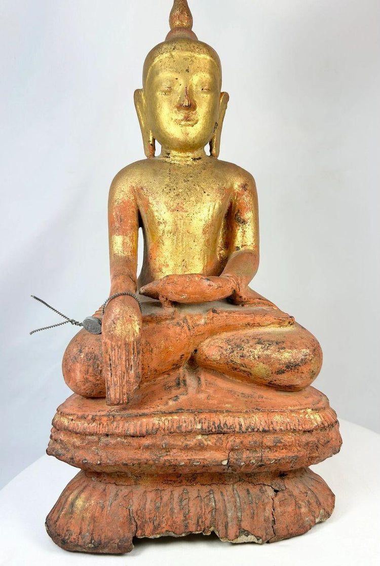 Large antique Burmese Shan-style Buddha statue with original gilt finish, seated in dhyana mudra on a tiered lotus base. 19th-century Southeast Asian devotional sculpture showing serene expression, aged surface, and traces of red lacquer beneath gold.