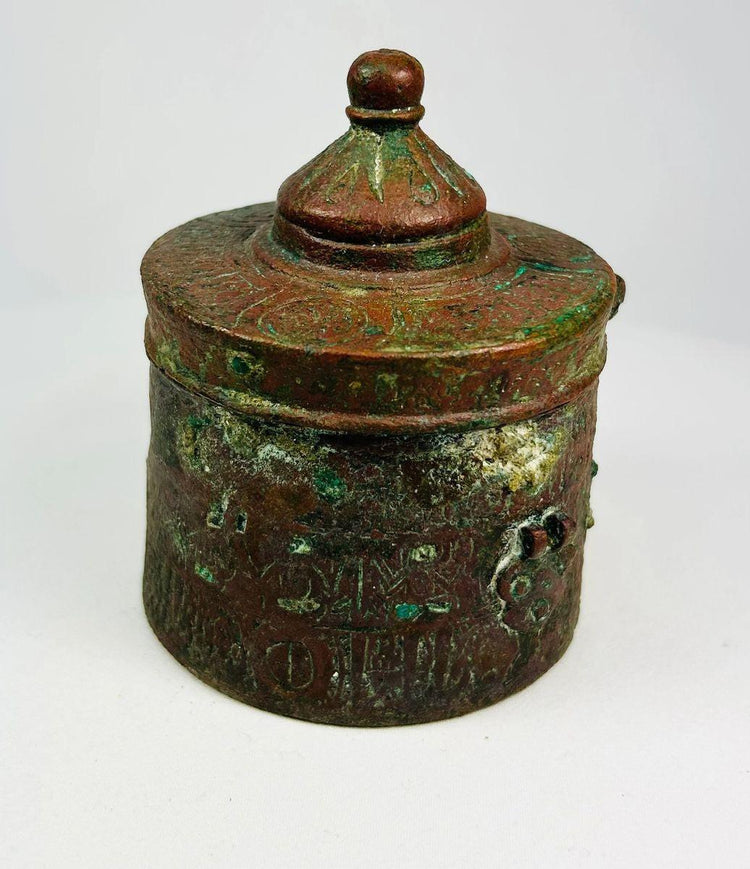 Large Islamic Khorassan bronze inkwell, 10th–12th century, with domed lid and intricate engraved motifs, aged patina and verdigris surface.