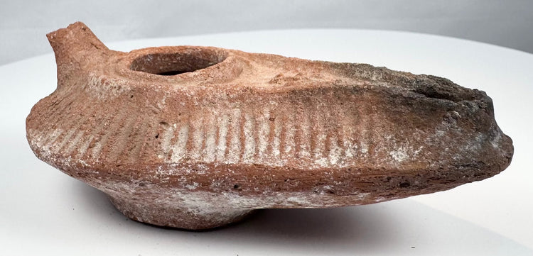 Ancient Levantine terracotta lamp with central filling hole and extended wick opening