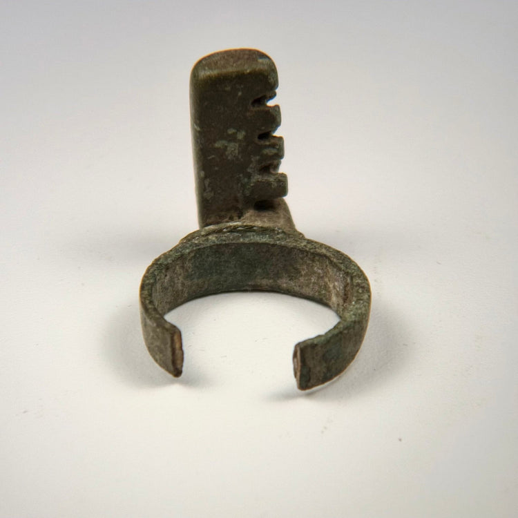 Ancient Roman functional ring key with rectangular locking bit, weathered bronze surface, and open rear band