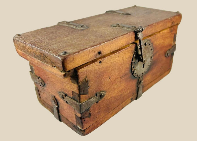 Antique Himalayan lockbox, circa 1780–1820, crafted from elmwood with original hand-forged iron fittings, circular hasp plate, ornate key, and rich aged patina. Historical chest from Northern India, Nepal, or Tibet used for safeguarding valuables.