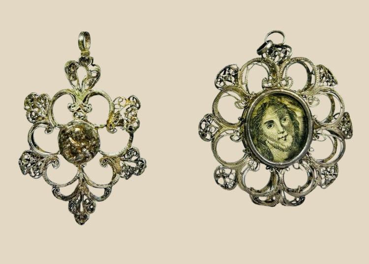 Antique 19th-century Catholic devotional pendant with ornate silver filigree frame and engraved portrait of Christ under glass, likely Italian or Spanish origin.