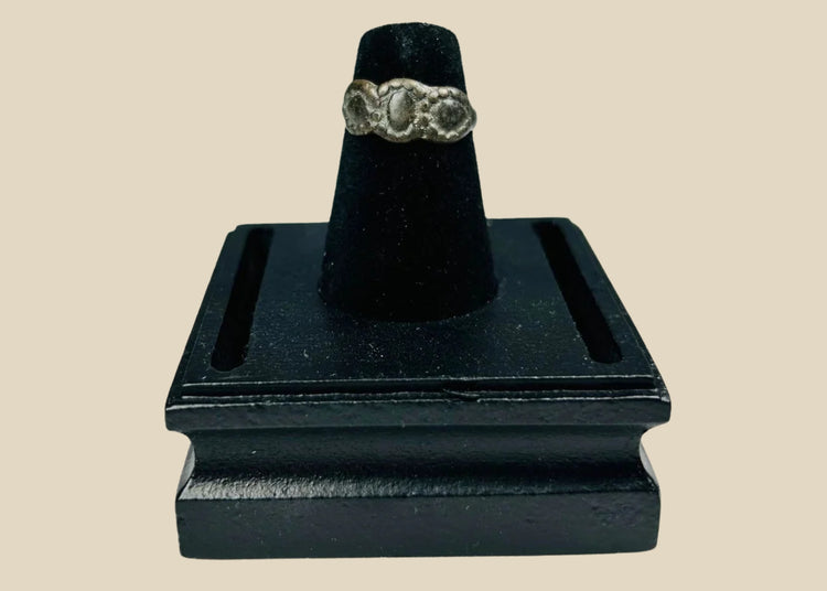 Ancient Late Roman–Byzantine silver ring featuring a clustered bezel of three oval motifs with natural aged patina, circa 300–600 CE.