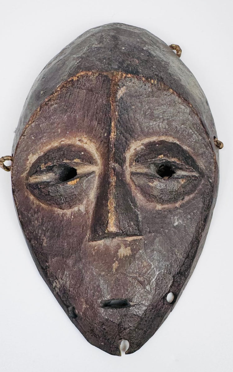 Authentic Lega passport mask featuring elongated facial form and stylized almond-shaped eyes.