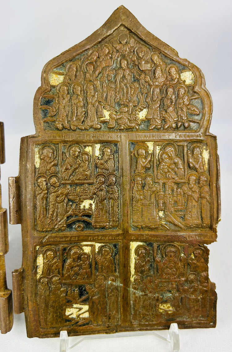 Historic Russian religious icons in cast bronze showing Christian holy figures and Cyrillic text