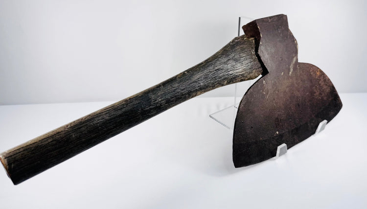 Oblique view of an antique New York broadhead axe showing the blade, handle junction, and forged construction.