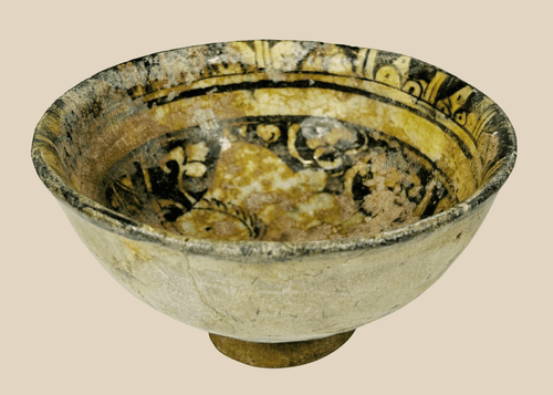 Medieval Islamic glazed ceramic bowl with figural design from Raqqa ware tradition