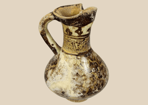 Medieval Islamic Kashan ceramic ewer with pseudo Kufic decoration and trefoil spout