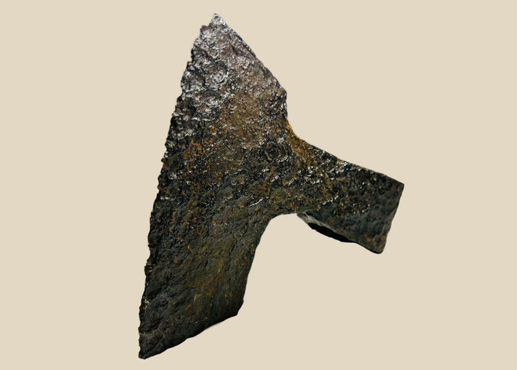 Ancient medieval iron axe head with broad bearded blade and hollow socket, Viking and early European design, circa 10th–14th century CE.