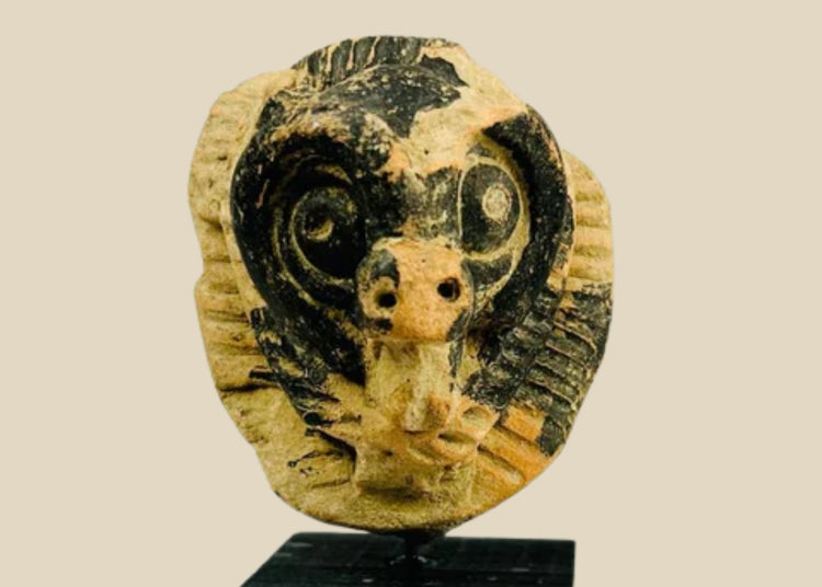 Pre-Columbian terracotta mask fragment from Mesoamerica, Classic Period (500–900 AD), depicting an animal face with bold eyes and snout, incised patterns, and traces of black pigment.