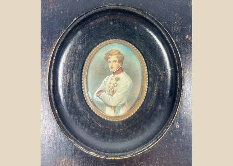 Finely painted mid–late 19th-century miniature portrait of Napoleon II, Duke of Reichstadt, in Austrian white dress uniform with red collar and blue sash, gouache on wafer under glass, set in original ebonized wood frame with brass bezel, Central Europe, circa 1860–1885