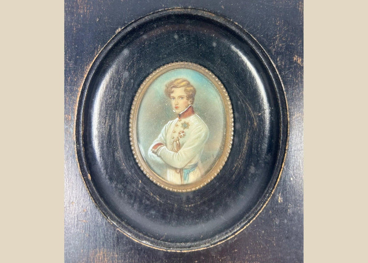 Finely painted mid–late 19th-century miniature portrait of Napoleon II, Duke of Reichstadt, in Austrian white dress uniform with red collar and blue sash, gouache on wafer under glass, set in original ebonized wood frame with brass bezel, Central Europe, circa 1860–1885