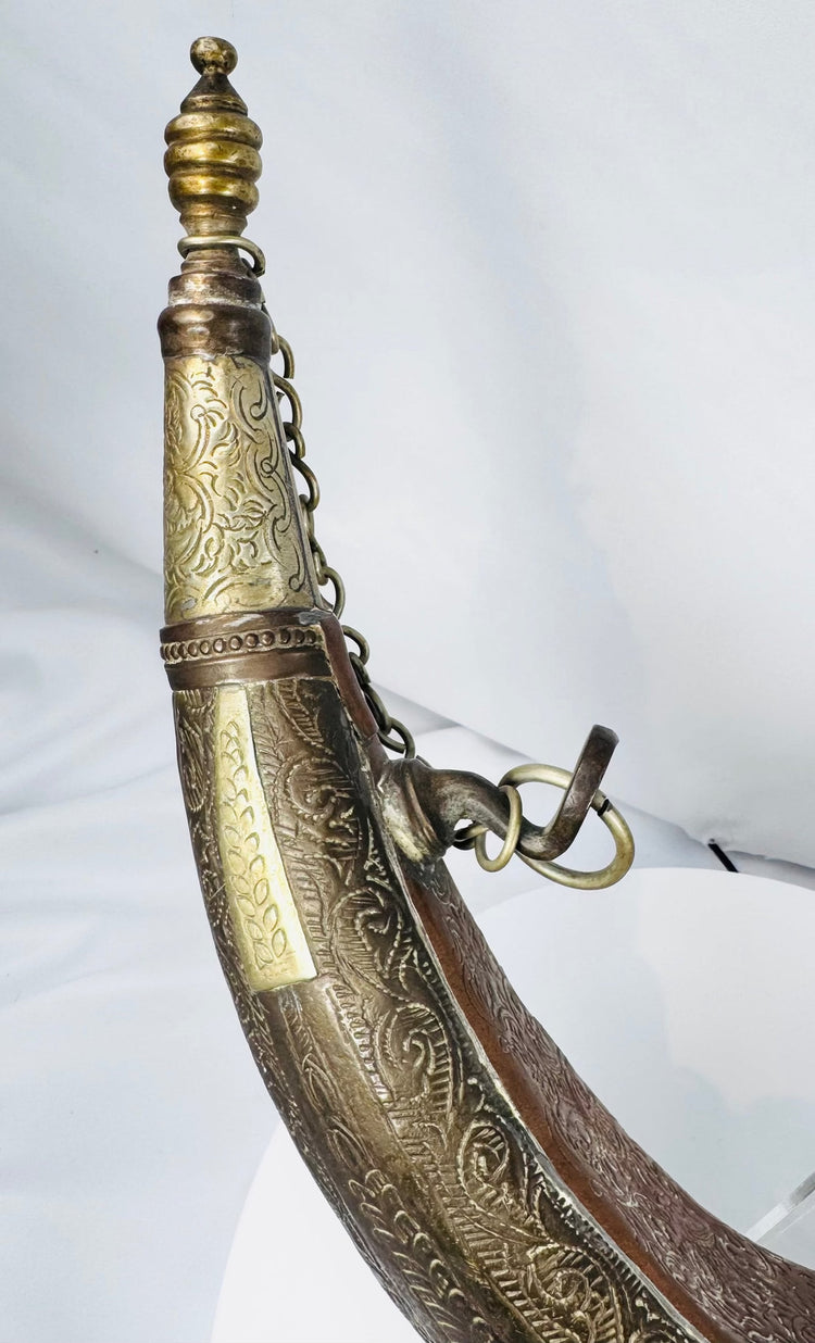 Engraved Moroccan gunpowder container with crescent profile and copper-toned surface