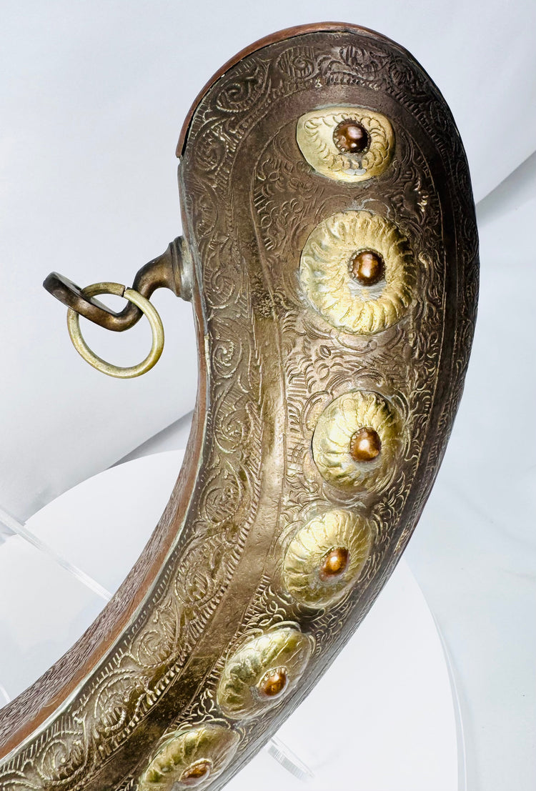 North African crescent powder flask with embossed flower bosses and aged patina