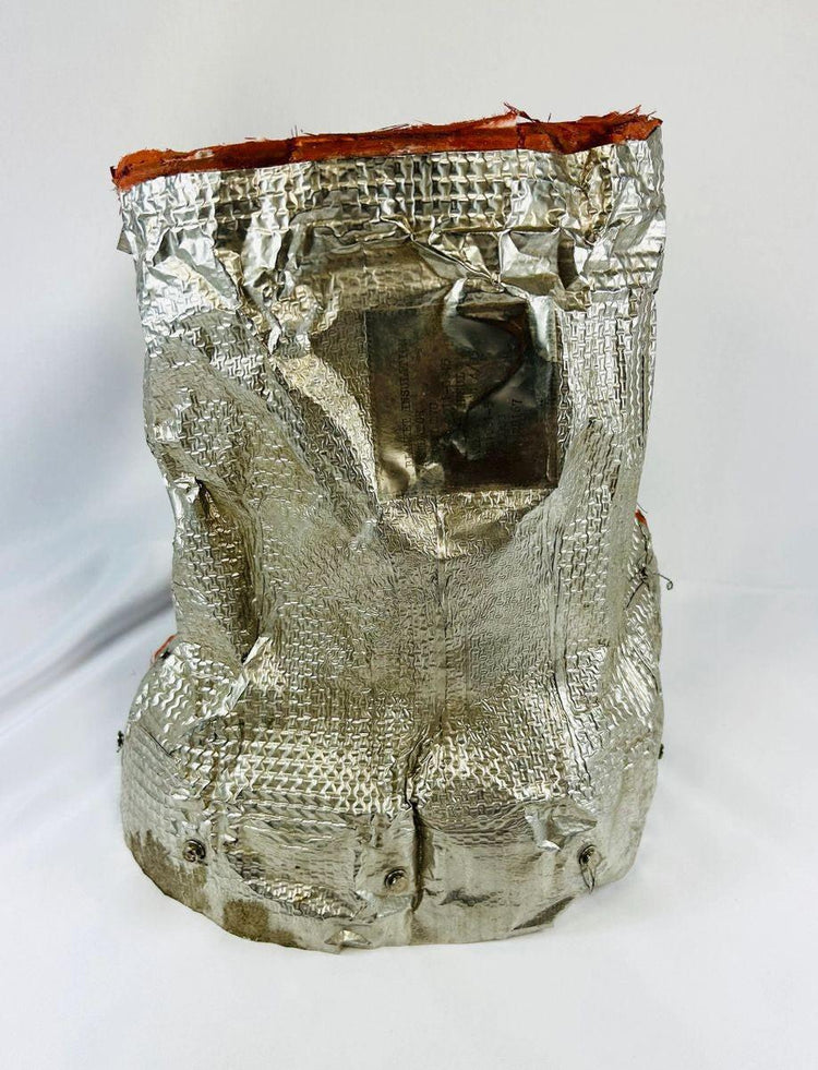 Flown NASA Space Shuttle insulation panel made of fibrous silica batting, stamped April 1983 with serial number and manufacturer code, used in shuttle thermal protection system, approximately 11 x 10 inches.