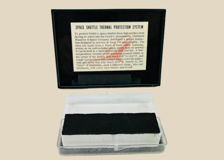 Authentic NASA Space Shuttle HRSI tile from the 1980s, silica-based ceramic with black Reaction Cured Glass (RCG) coating, designed for high-temperature reentry, displayed in original NASA-issued case with documentation.