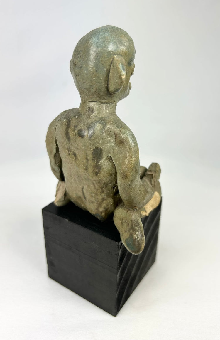 Nayarit Chinesco clay figure showing classic mask-like face and compact seated form