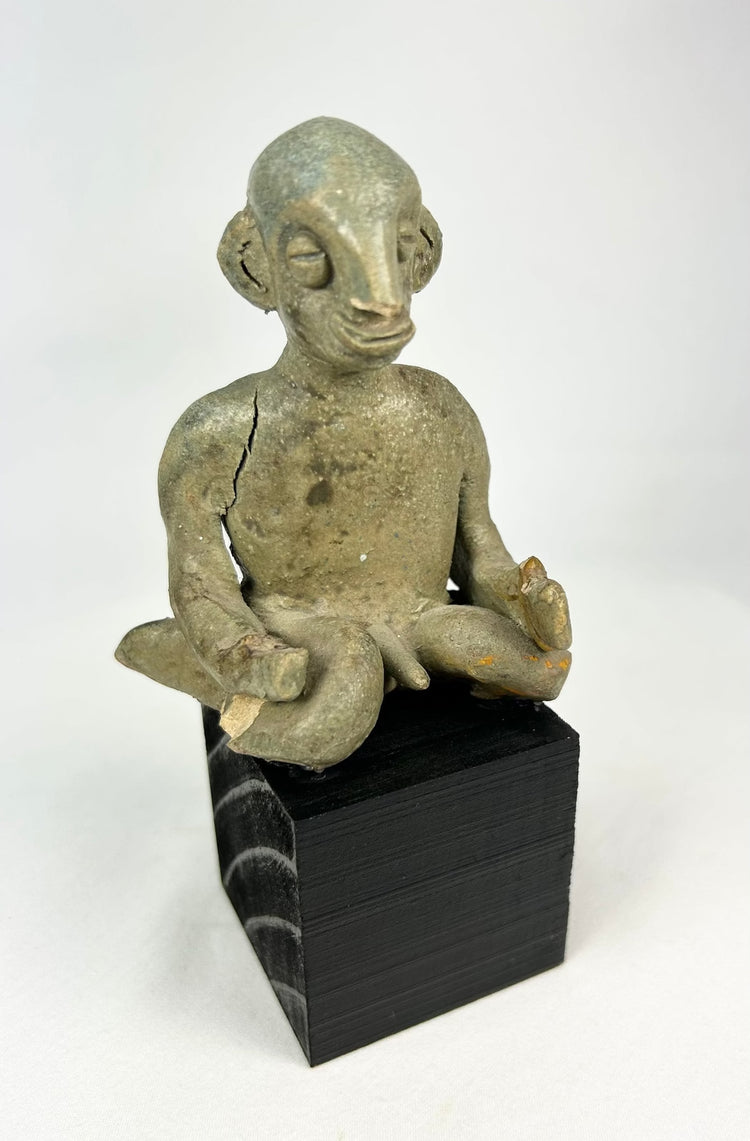 Ancient Nayarit shaft-tomb terracotta figure with crossed-leg posture and slit eyes