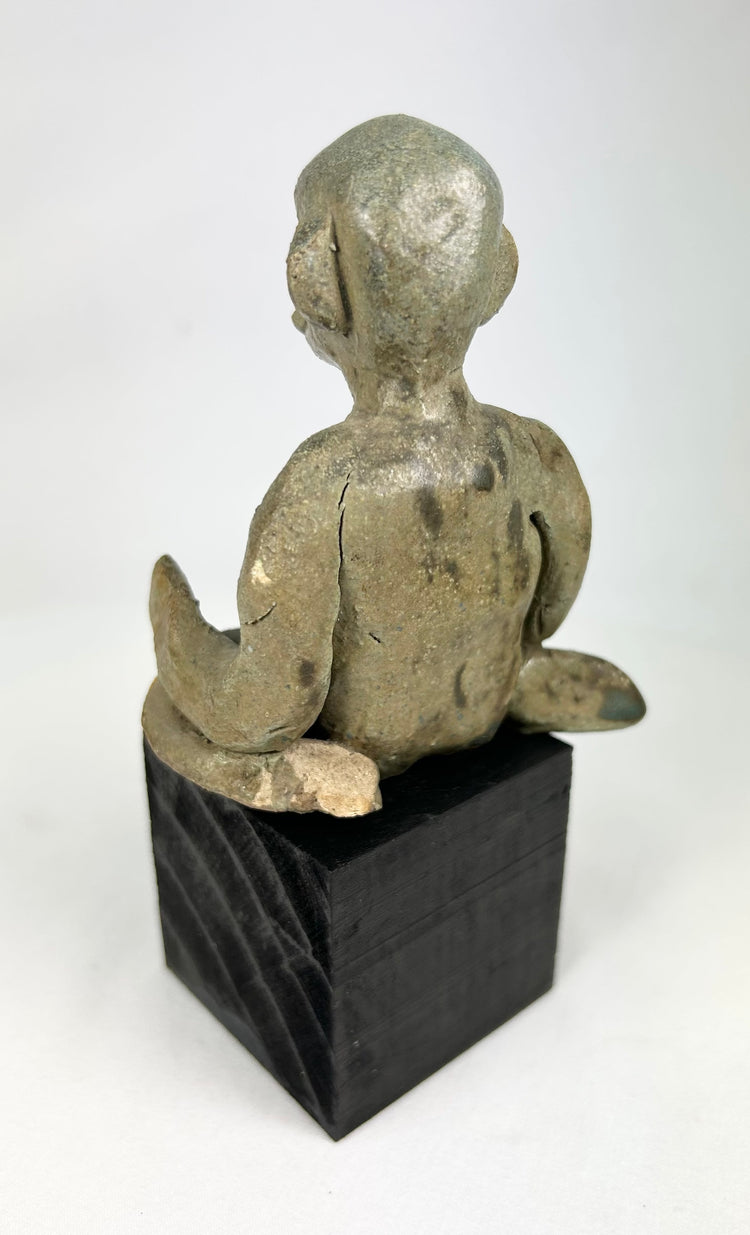 Pre-Columbian Nayarit seated male sculpture with crossed legs and stylized features