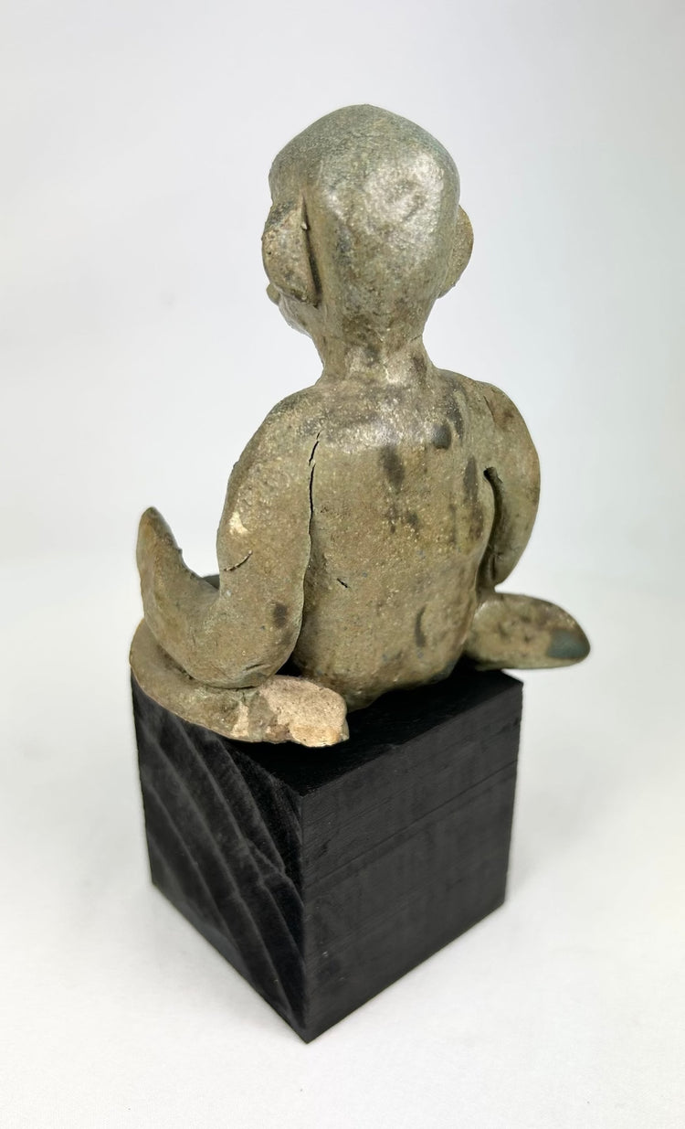Pre-Columbian Nayarit seated male sculpture with crossed legs and stylized features