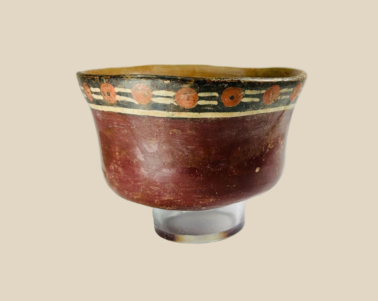 Early Nazca terracotta bowl, circa 100–300 AD, with flared rim and vibrant polychrome decoration of red circular and black-cream geometric motifs, reflecting pre-Columbian ceremonial artistry.