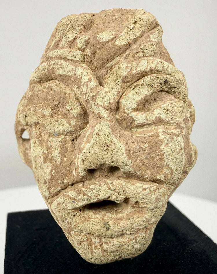 Near Eastern limestone idol head with stylized facial features, possibly dating to the 2nd–1st millennium BCE.