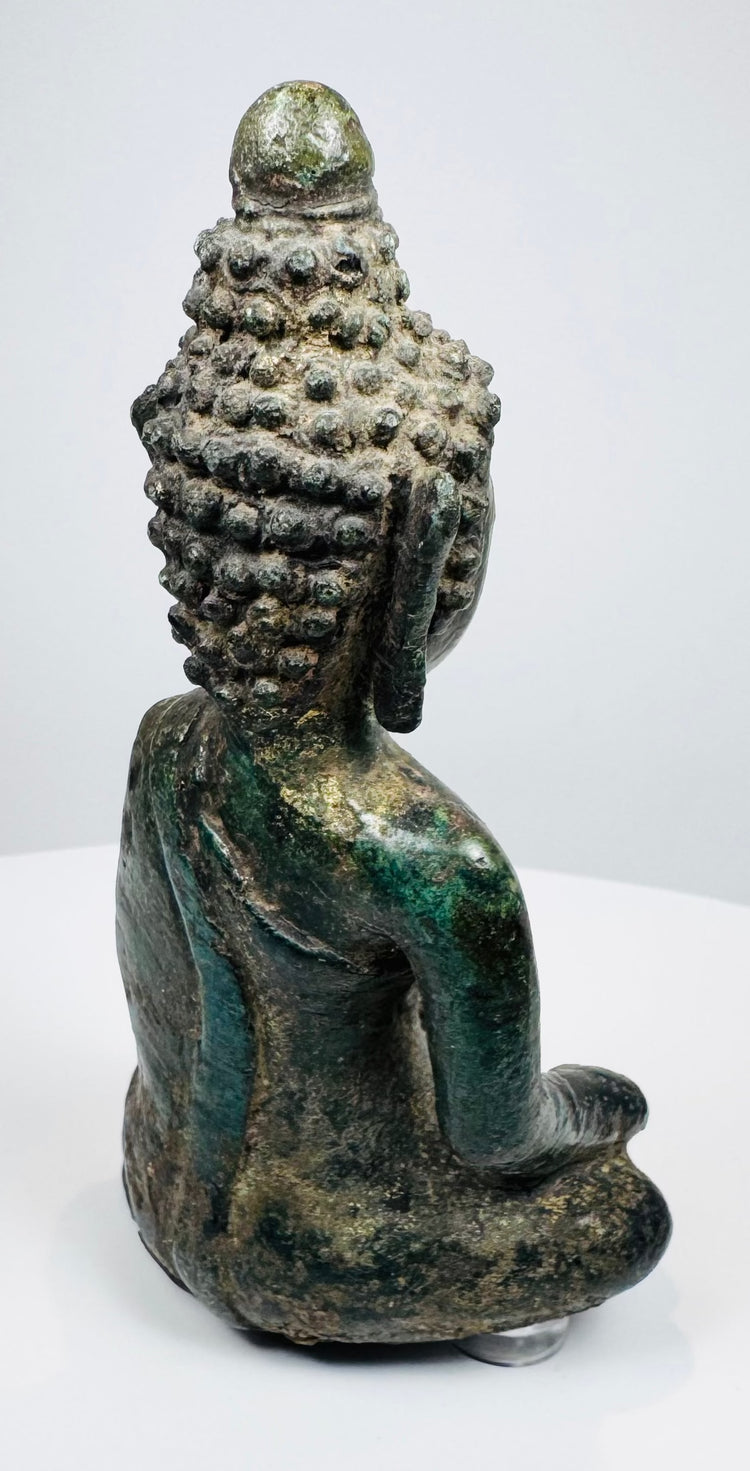 Rear three-quarter view showing the Buddha’s curled hair and rounded ushnisha