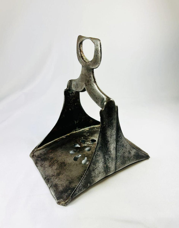 17th-century Ottoman cavalry stirrup in forged steel with traces of silver inlay, shown against a white background.