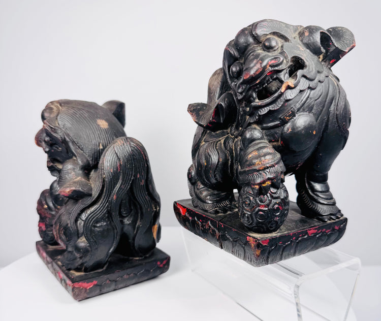 Opposite side view of Chinese guardian lions showing mirrored poses, brocade balls and surviving red polychrome decoration