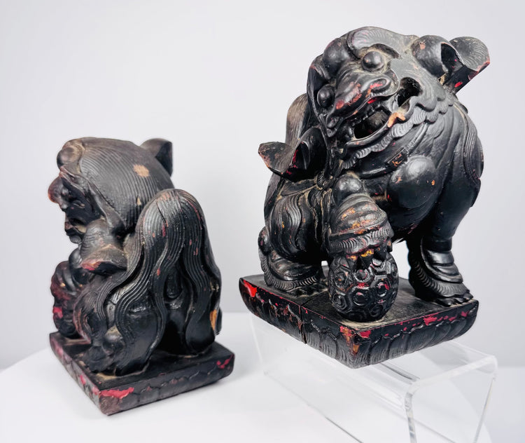 Opposite side view of Chinese guardian lions showing mirrored poses, brocade balls and surviving red polychrome decoration