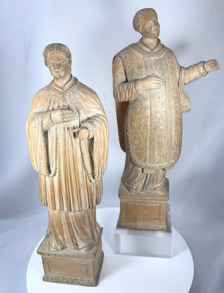 Pair of ecclesiastical wooden sculptures likely representing saints or clergy from 18th–19th century Europe.
