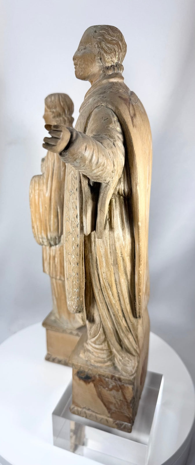 Antique European saint sculptures carved from hardwood with visible tool marks and natural wear.