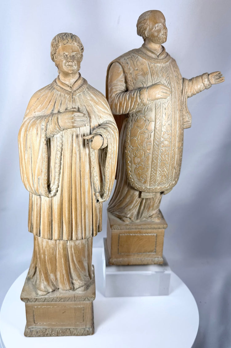 Hand-carved saintly figures from Continental Europe with decorative vestments and devotional character.