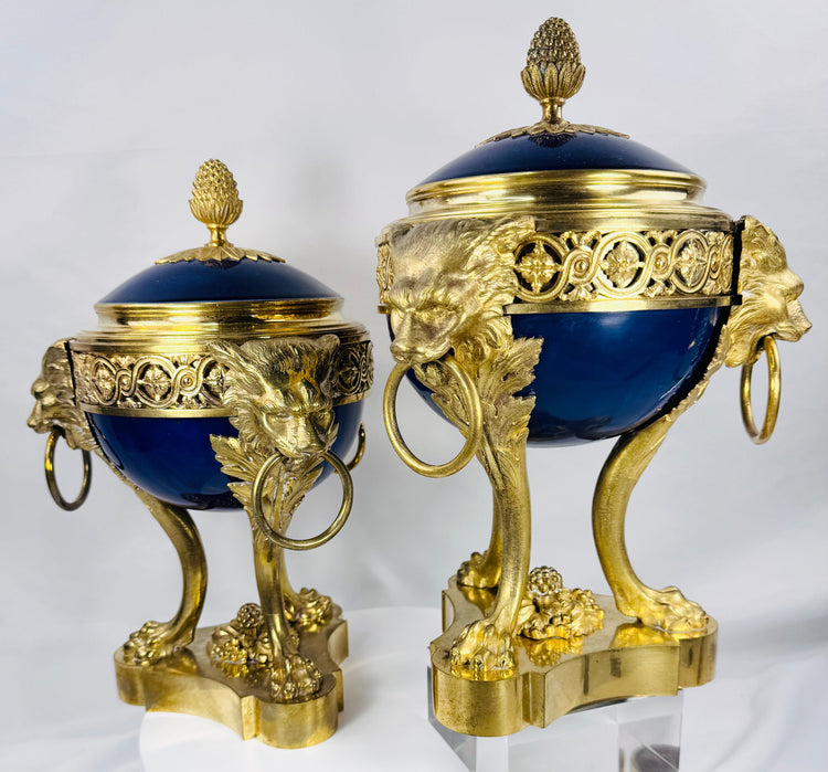 Antique French decorative vases with cobalt-blue porcelain, openwork gilt bronze galleries, and pinecone finials.