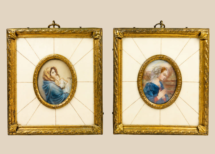 Pair of 19th century hand-painted miniature portraits in gilt frames with ivory-style panel insets. Depicting devotional female figures, one in prayer and one cradling a child. Original rectangular frames with oval portrait centers, fine detail and patina.