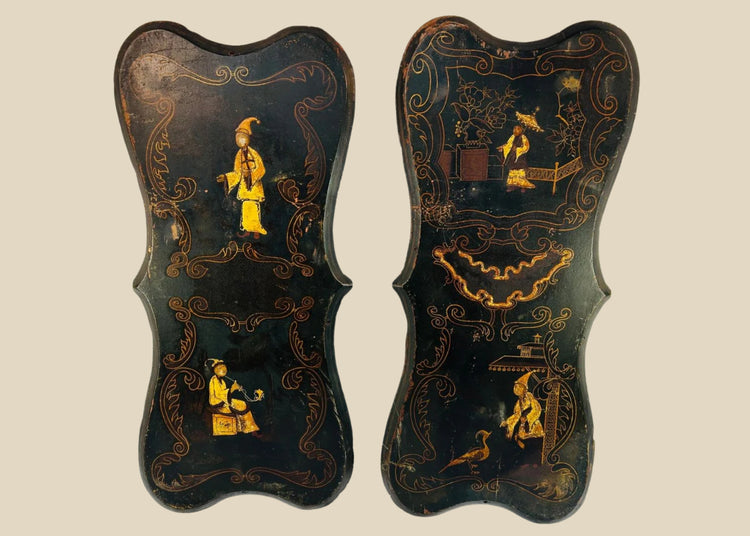 Pair of 19th-century Chinoiserie wall panels with hand-painted Asian-inspired figures, floral motifs, and gilt decoration on shaped black lacquered wood, circa 1850–1880.