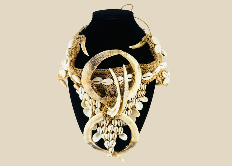 Early 20th century Papua New Guinea ceremonial apron, featuring boar tusks, cowrie shells, and natural fiber bindings, used in tribal initiations and dances, ethnographic Melanesian artifact