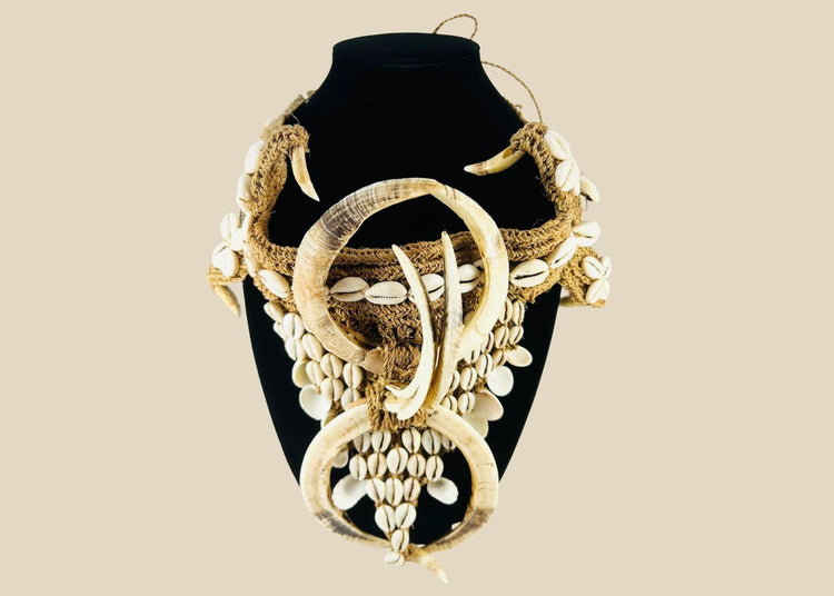 Early 20th century Papua New Guinea ceremonial apron, featuring boar tusks, cowrie shells, and natural fiber bindings, used in tribal initiations and dances, ethnographic Melanesian artifact