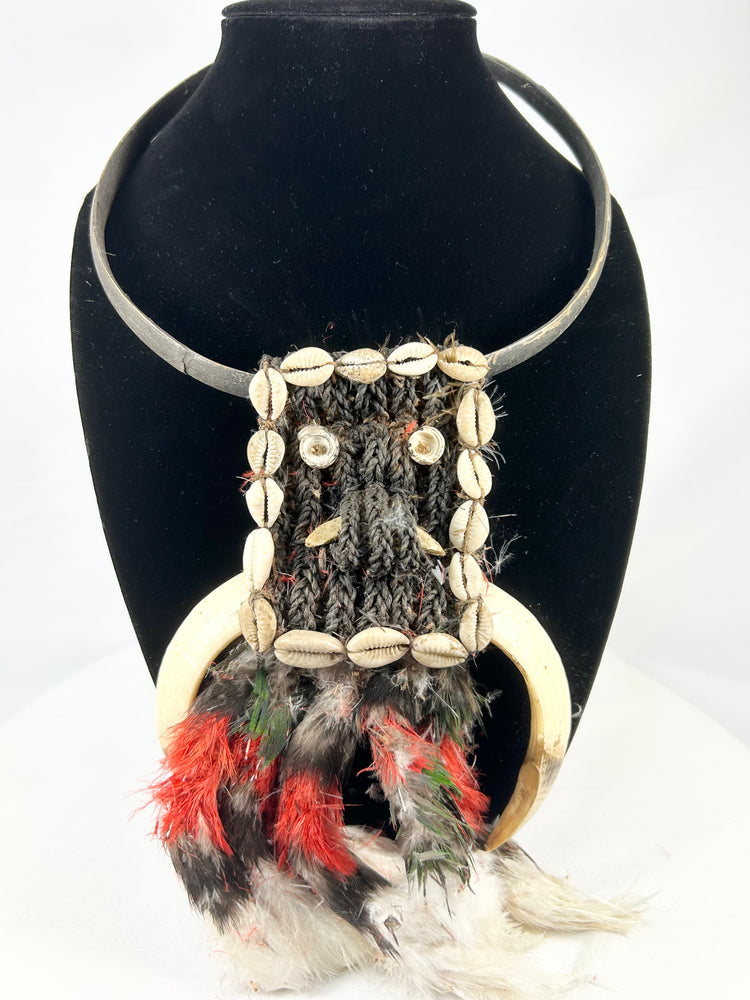 20th century Papua New Guinea tribal ceremonial necklace, braided plant fiber with shell and bone elements, red and black feathers, Oceanic ritual ornament, mounted for display