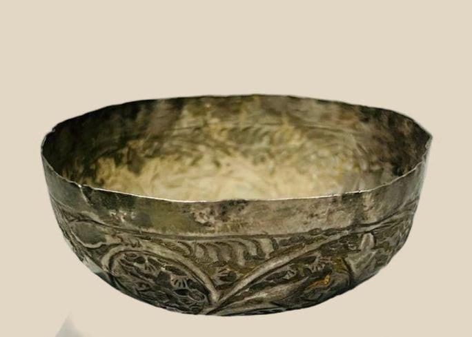 Seljuk-period silver unguent bowl from Persia, 12th–13th century CE, with engraved floral and geometric motifs, used for oils or perfumes, showing natural silver patina.